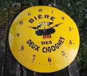 Horloge maille publicitaire jaune ronde bombe bire deux cigognes
